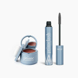 The PrimePrometics™ Beauty Essentials set, featuring a blue compact with blush and mirror beside an open PrimeLash mascara, is displayed on a plain white background.