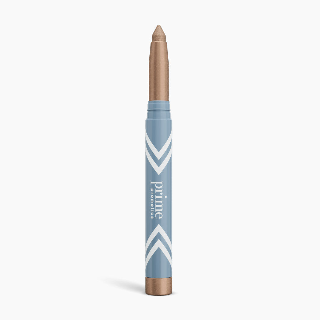 The PrimePrometics™ PrimeEyes Eye Brightener is a blue and gold makeup crayon with white chevrons and "prime promise" text, offering illuminating eyeshadow and eye lift effects for women over 50. It stands upright on a white background.