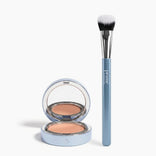 The PrimePrometics™ Bye Dark Circles Set, featuring a blue makeup brush and an open cream foundation compact with a mirror, is displayed on a white background.