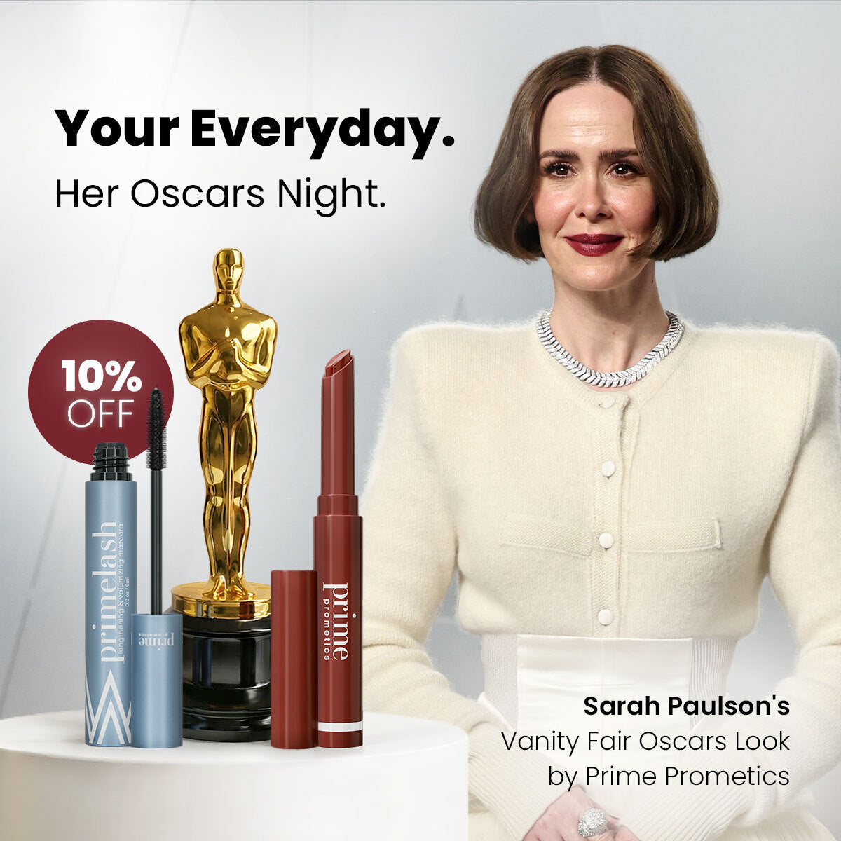 A woman in a white outfit stands beside an Oscar statue and two makeup products, with text promoting 10% off Prime Prometics cosmetics and featuring her Vanity Fair Oscars look.