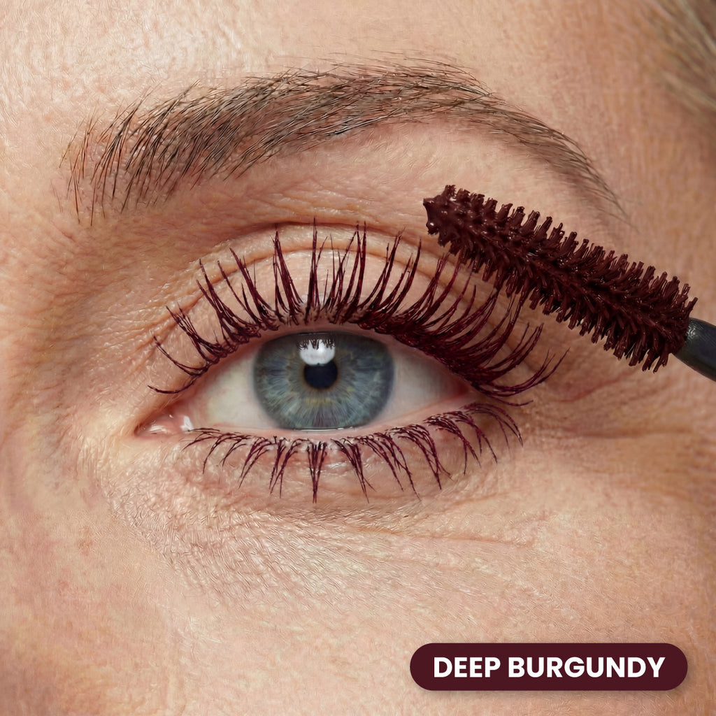 Closeup of an eye with Prime Prometics PrimeLash Mascara in Burgundy applied with the brush wand
