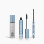 The PrimePrometics™ Prime Heroes Set features three silver and blue products: a Color Changing Foundation bottle, an exposed-wand PrimeLash Mascara tube, and a twist-up eyeliner pencil, all branded “Prime Lash.”.