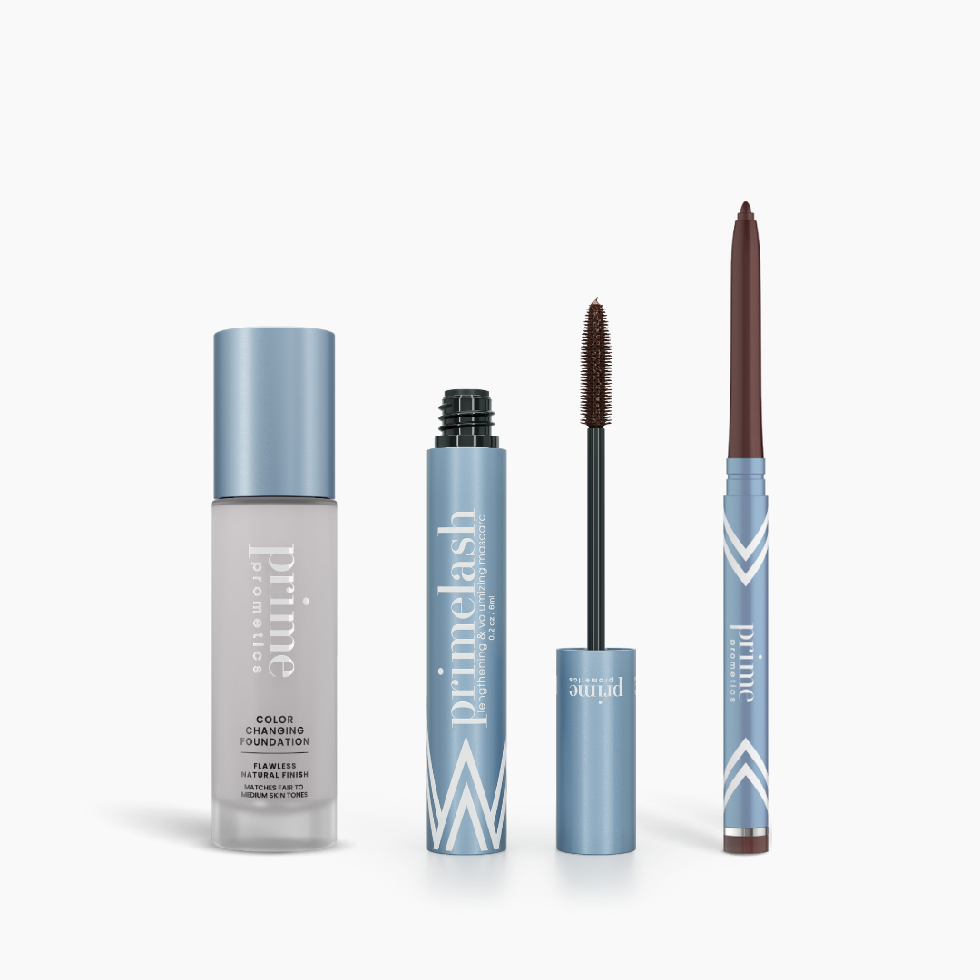 The PrimePrometics™ Prime Heroes Set features three makeup essentials—a Color Changing Foundation, a PrimeLash Mascara with visible wand, and a PrimeEyes Glide eyeliner pencil—all in sleek light blue packaging with white accents.