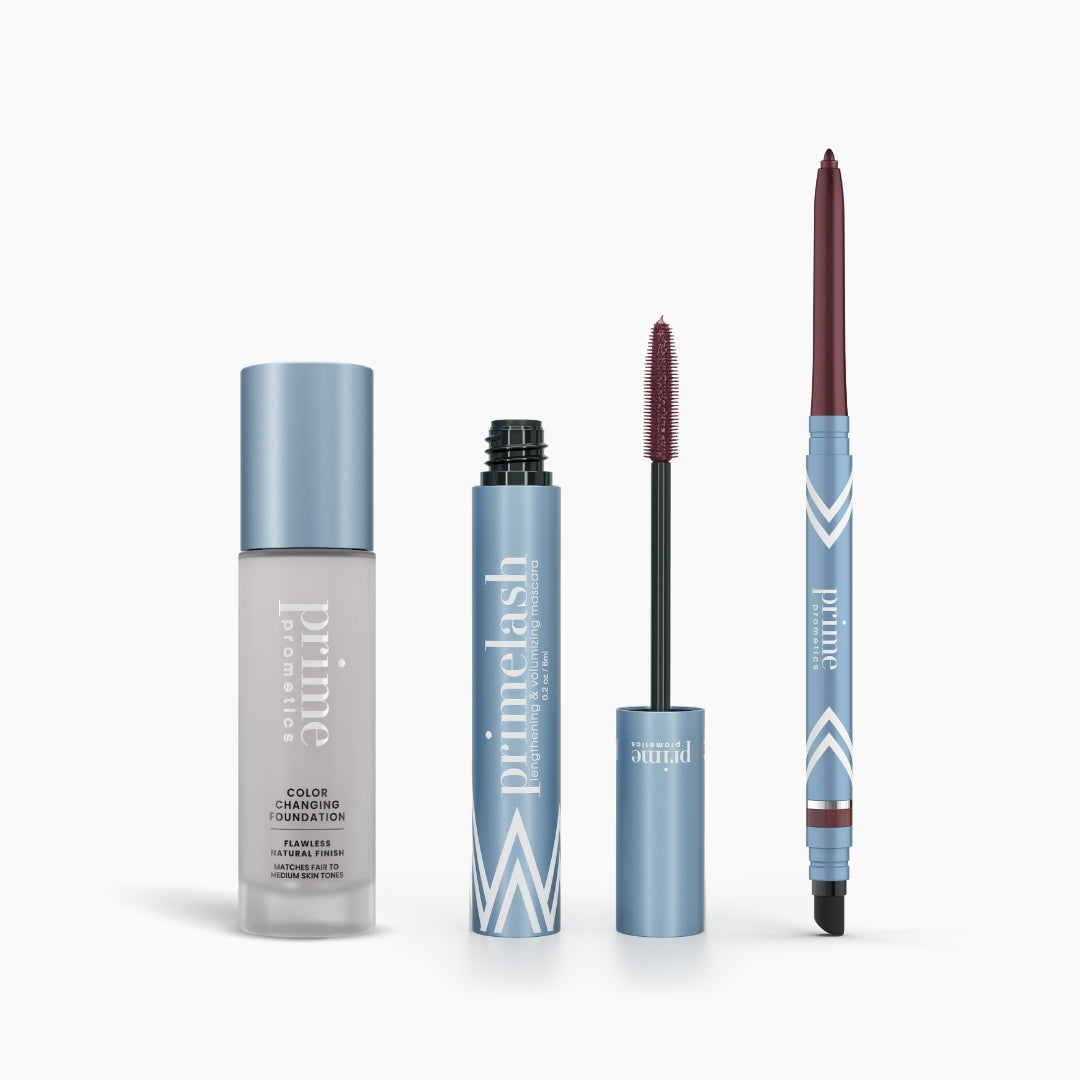 The PrimePrometics™ Prime Heroes Set features three blue cosmetics—Color Changing Foundation, PrimeLash Mascara with a mauve brush, and PrimeEyes Glide retractable eyeliner—all labeled “prime” on a white background.