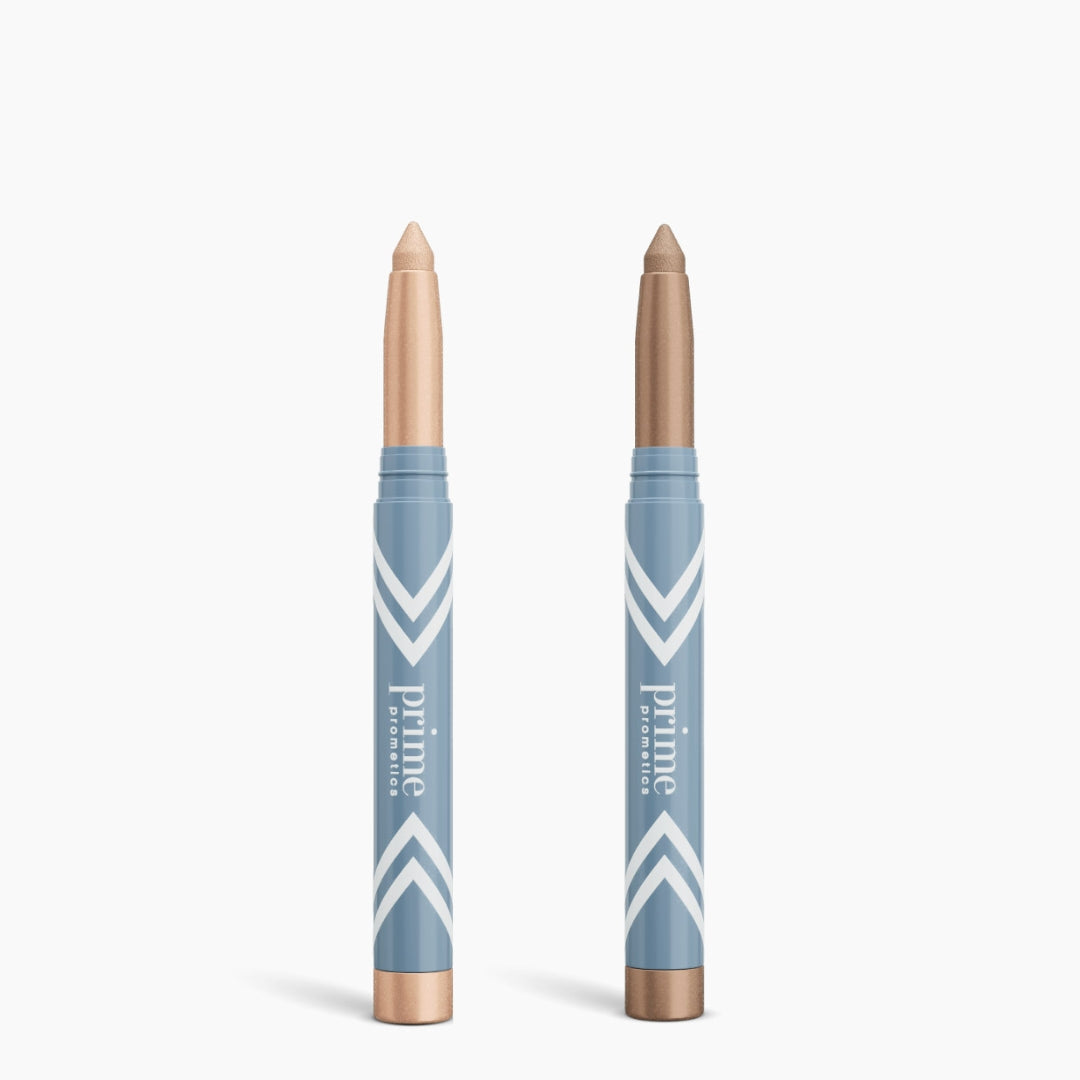 Two blue PrimePrometics™ 2pcs PrimeEyes Eye Brightener sticks with white chevron designs and "prime" text—one in light beige, one in medium brown—for brightening eyes or use as under eye cream. Caps are removed and set below.