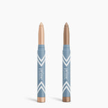 Two blue PrimePrometics™ 2pcs PrimeEyes Eye Brightener sticks with white chevron designs and "prime" text—one in light beige, one in medium brown—for brightening eyes or use as under eye cream. Caps are removed and set below.