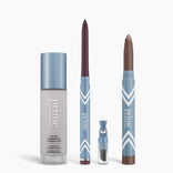 The PrimePrometics™ All-Day Confidence Bundle features four upright makeup products in blue and silver: a color-changing foundation, a glide eyeliner pencil, a small vial, and a metallic eyeshadow stick.