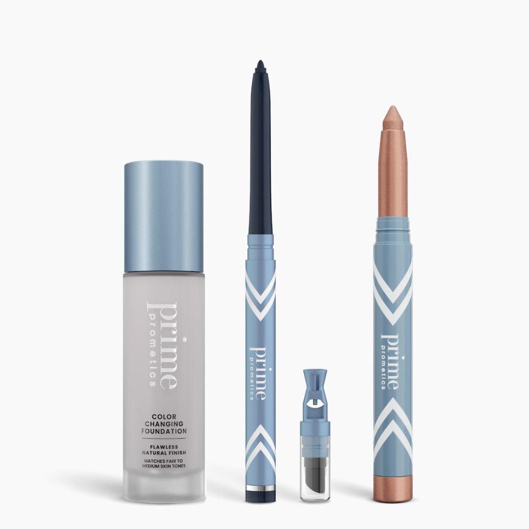 The PrimePrometics™ All-Day Confidence Bundle features four blue and silver makeup items—including a color-changing foundation, a dark blue eyeliner pencil, a small cylindrical container, and a shimmery beige “Prime Promise” crayon—shown vertically on white.