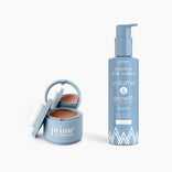 The PrimePrometics™ Flawless Hair Set features a blue compact with mirror and puff, alongside a matching pump bottle of “primehair lush n thick volume & growth shampoo,” both in blue with white accents.