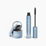 The PrimePrometics™ Beauty Essentials set features a blue compact with mirror and puff for hairline powder or makeup, alongside an opened blue tube of PrimeLash mascara and black brush wand.
