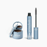 The PrimePrometics™ Beauty Essentials set, featuring a blue hairline powder container with mirror and puff and a blue PrimeLash mascara tube with wand, is displayed open on a white background.