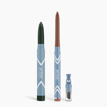 The Eye Lift Duo by PrimePrometics™—a dark green crayon, a brown crayon, and a small blue “prime promise” container—stands upright against a white background, showcasing an eyeliner for women over 50 and an illuminating eye tint.