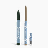 Three PrimePrometics™ Eye Lift Duo pencils in dark green, bronze, and black with varied tips stand upright with a small blue sharpener on a white background—ideal eyeliner for women over 50.