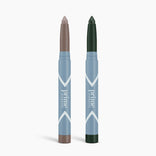 Two PrimePrometics™ PrimeEyes Eyeshadow Matte sticks with blue and white packaging stand upright; the left features a taupe matte shade, the right a deep green, both shown against a plain white background.
