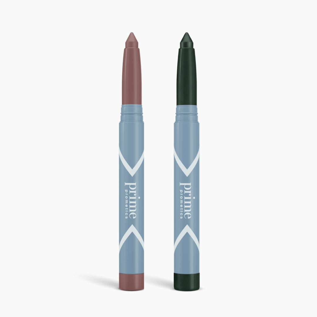 Two blue-gray makeup sticks—one mauve, one dark green—stand upright on a white background, showcasing the 2pcs PrimeEyes Eyeshadow Matte by PrimePrometics™ for easy matte eyeshadow looks.