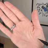 A hand with two rings is shown while a black PrimePrometics™ 3pcs PrimeEyes Liquid Eyeliner draws realistic, detailed lines that blend seamlessly with the natural creases and folds of the palm.