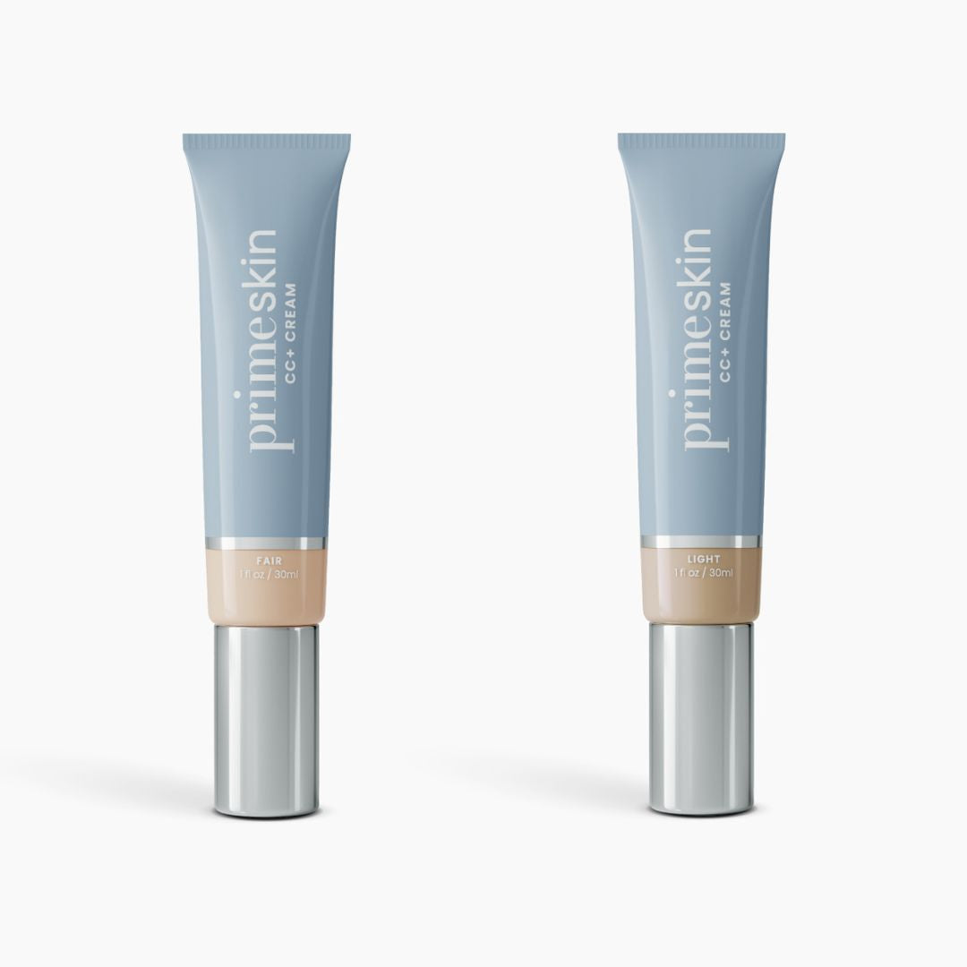 Two upright blue tubes of PrimePrometics™ 2pcs PrimeSkin CC+ Cream, labeled Fair and Light, feature silver caps and beige labels. This lightweight foundation blurs pores on a light background.