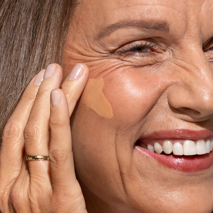 Woman applying PrimeSkin CC+ Cream