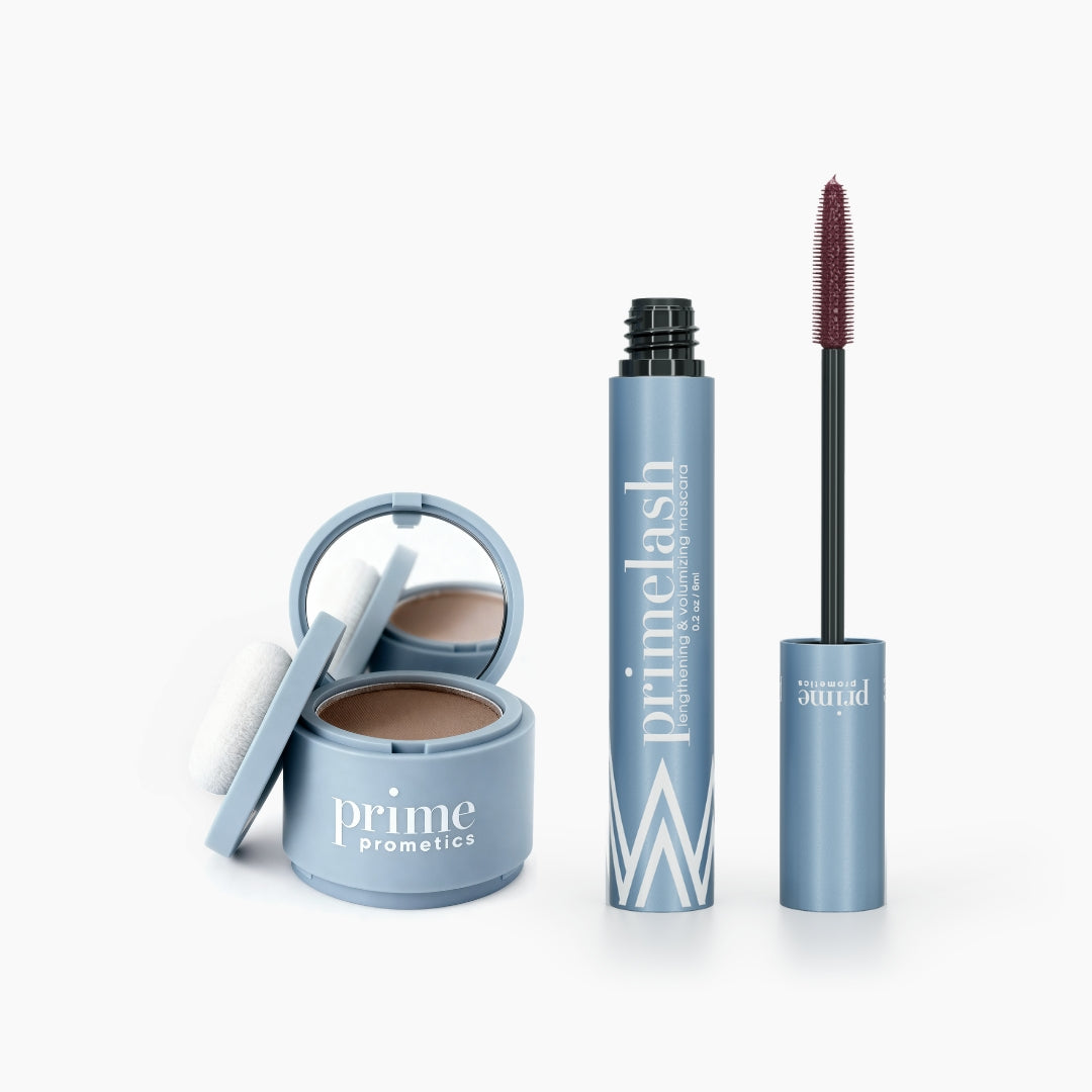 The Beauty Essentials Set by PrimePrometics™ features an open compact of Hairline Powder with mirror and puff, and a tube of Mascara with the wand extended, both displayed on a white background.