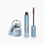 A light blue Beauty Essentials Set compact with a mirror and puff is next to an open maroon-brushed mascara. Both feature the PrimePrometics™ brand, displayed on a sleek white background.