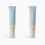Two tubes of PrimePrometics™ 2pcs PrimeSkin CC+ Cream in ivory stand upright against a white background. The light blue tubes with silver caps blur pores, making them an ideal lightweight foundation for women over 50.