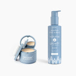 A blue compact with powder and mirror is beside a matching blue pump bottle from the PrimePrometics™ Flawless Hair Set.