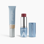 The PrimePrometics™ Complete Face Bundle, shown on a white background, features a blue tube of CC+ Cream (Light) with a beige cap and a matching blue Pigment stick with maroon tip, both placed side by side.