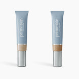 Two tubes of 2pcs PrimeSkin CC+ Cream by PrimePrometics™—one in Light, the other in Tan—stand upright in sleek blue packaging with silver caps and beige bases against a white background.