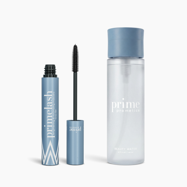A K.I.S.S Bundle by PrimePrometics™ featuring a blue Primelash Mascara tube with its wand removed, displayed alongside a clear Primeskin Beauty Water bottle, rests on a white background.