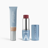 The PrimePrometics™ Complete Face Bundle features a blue PrimeSkin CC+ Cream tube, a mauve PrimeWand Pigment stick in a blue and silver case, and a matching blue cap, all displayed on a white background.
