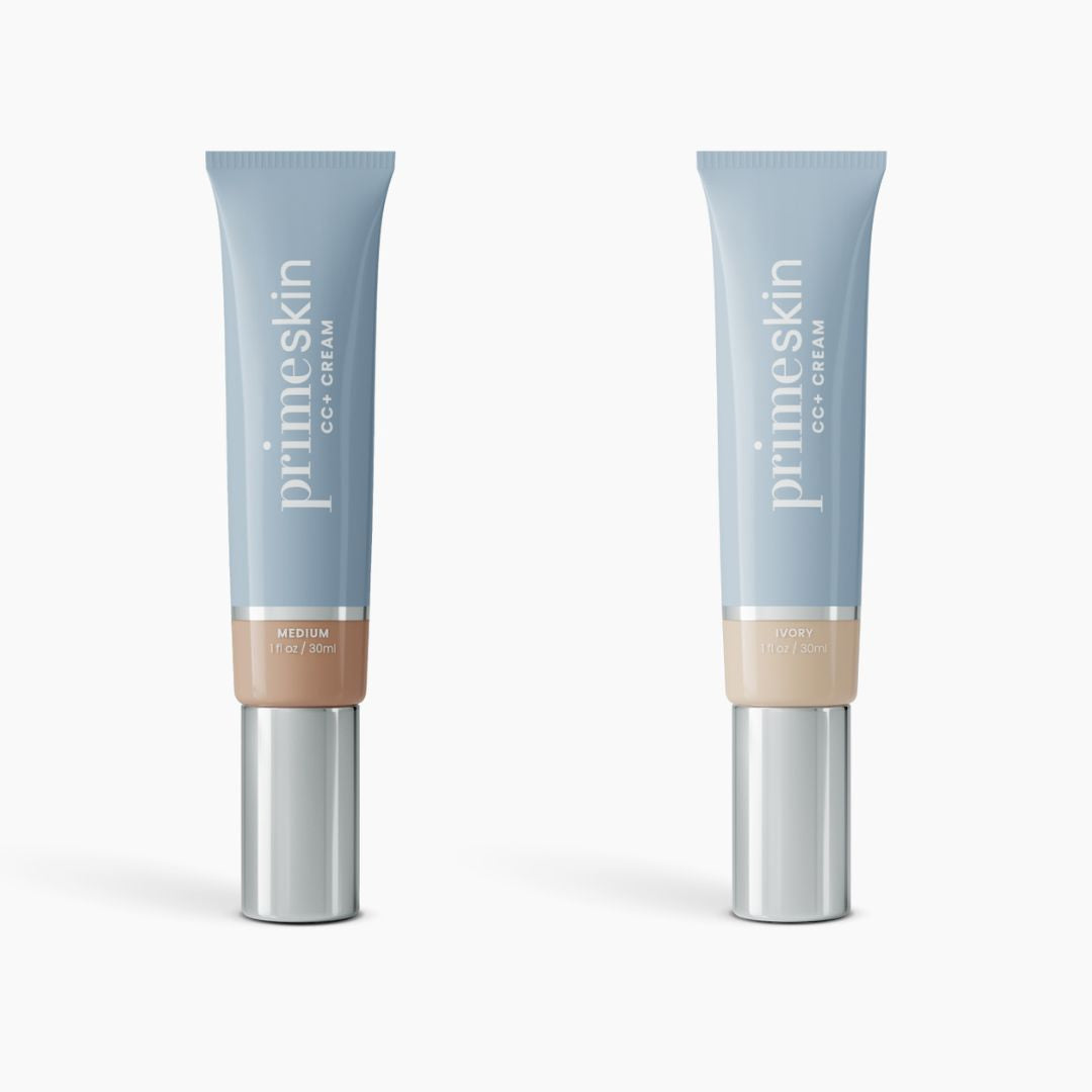 Two upright tubes of PrimePrometics™ 2pcs PrimeSkin CC+ Cream, in shades Medium and Ivory, blur pores and perfect skin. Both light blue with silver caps, they stand on a white background.
