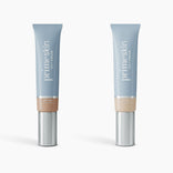 Two upright tubes of PrimePrometics™ 2pcs PrimeSkin CC+ Cream, in shades Medium and Ivory, blur pores and perfect skin. Both light blue with silver caps, they stand on a white background.