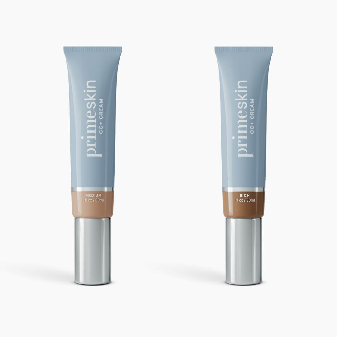 Two light blue 1oz tubes of PrimePrometics™ 2pcs PrimeSkin CC+ Cream, in Medium and Rich shades, with silver caps, displayed on white. This lightweight foundation blurs pores—ideal for women over 50.