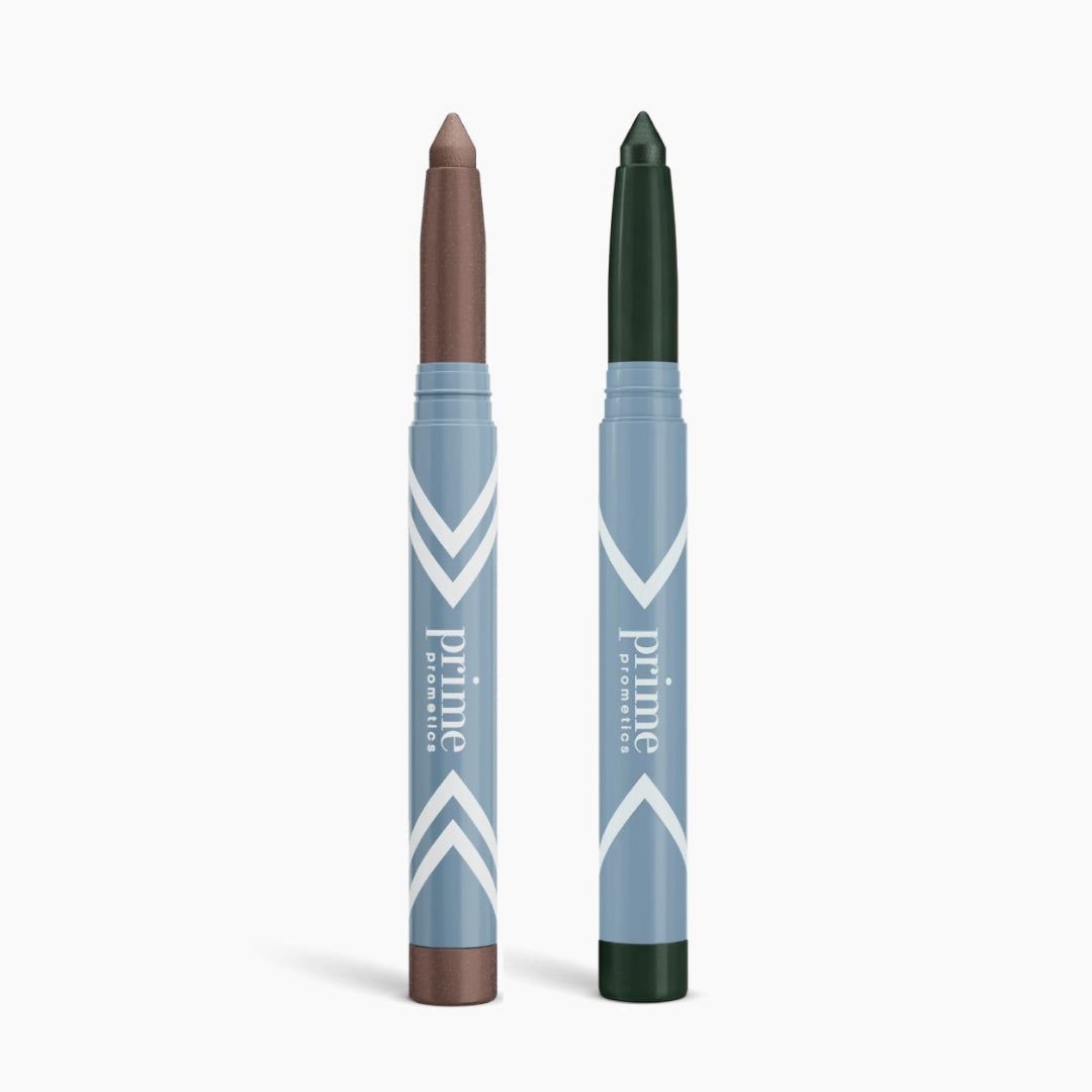 Two blue chevron-patterned sticks—one with a metallic brown tip, the other deep green—stand upright on white. Labeled 2pcs PrimeEyes Eye Brightener by PrimePrometics™, they're perfect for eye care and adding radiance.
