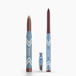 Two blue PrimePrometics™ Eye Lift Duo pencils stand upright—one with a metallic brown tip, the other maroon. In front sits a small sharpener with a clear cover.