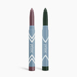 Two blue pointed sticks stand upright, labeled PrimePrometics™. The 2pcs PrimeEyes Eye Brightener duo—shades in mauve and deep green—offers versatile eye care on a sleek white background.