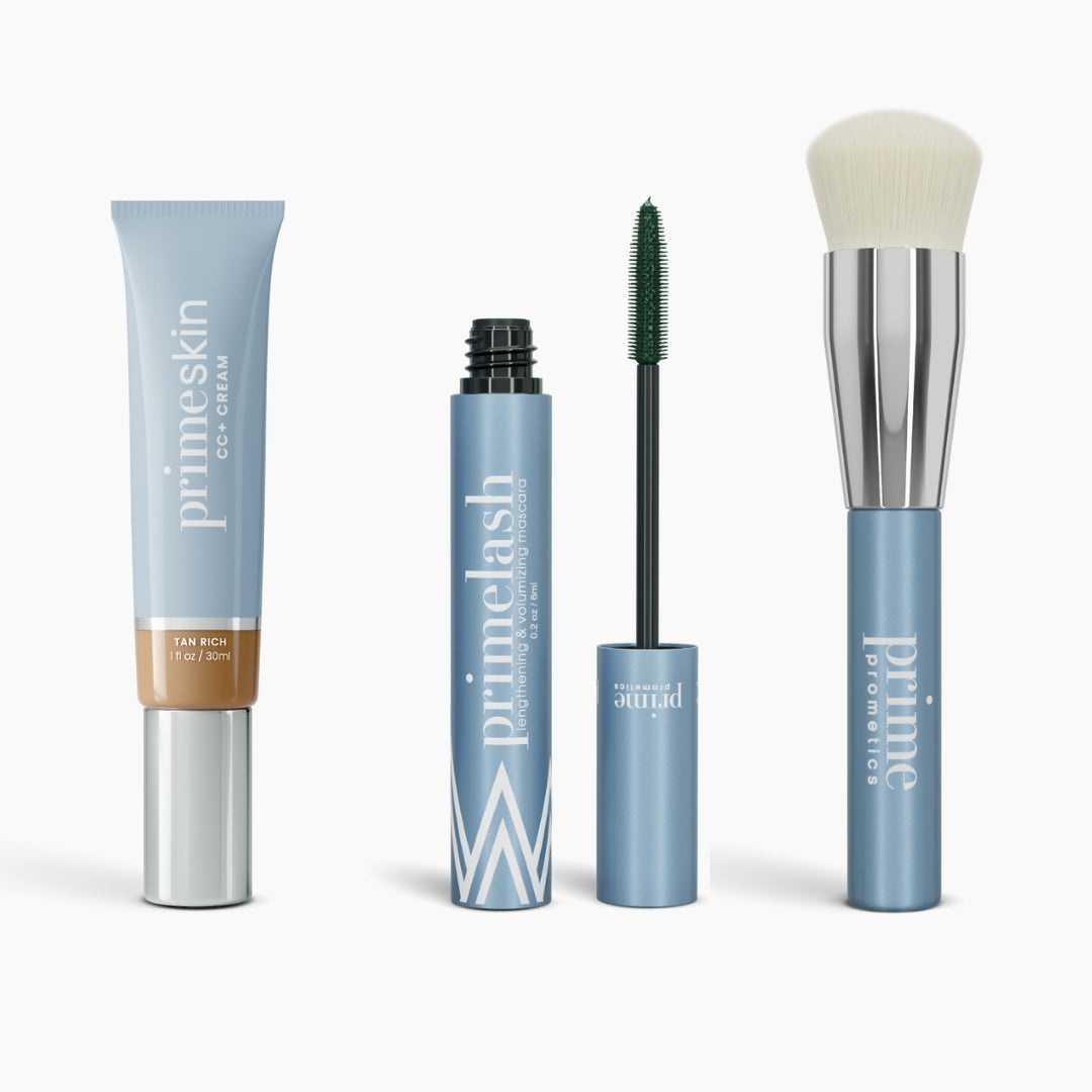 The PrimePrometics™ Effortless Beauty Complete Bundle features four blue and silver products—including CC+ Cream, Mascara with wand, and a white-bristled Foundation Brush—all upright on a white background.