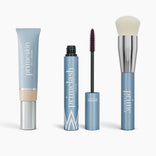 The Effortless Beauty Complete Bundle by PrimePrometics™ features four blue makeup products—CC+ Cream, mascara, a closed tube, and a foundation brush with white bristles—standing upright against a white background.