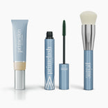 The Effortless Beauty Complete Bundle from PrimePrometics™ features a blue and silver Primeskin CC+ Cream, an open Primelash Mascara with green brush, a closed mascara tube, and a Foundation Brush—all standing upright.