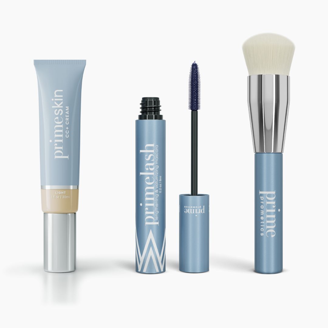 The Effortless Beauty Complete Bundle by PrimePrometics™ features a light blue tube of CC+ Cream, an open blue Mascara with wand, a closed mascara, and a Foundation Brush with a silver handle all standing upright.