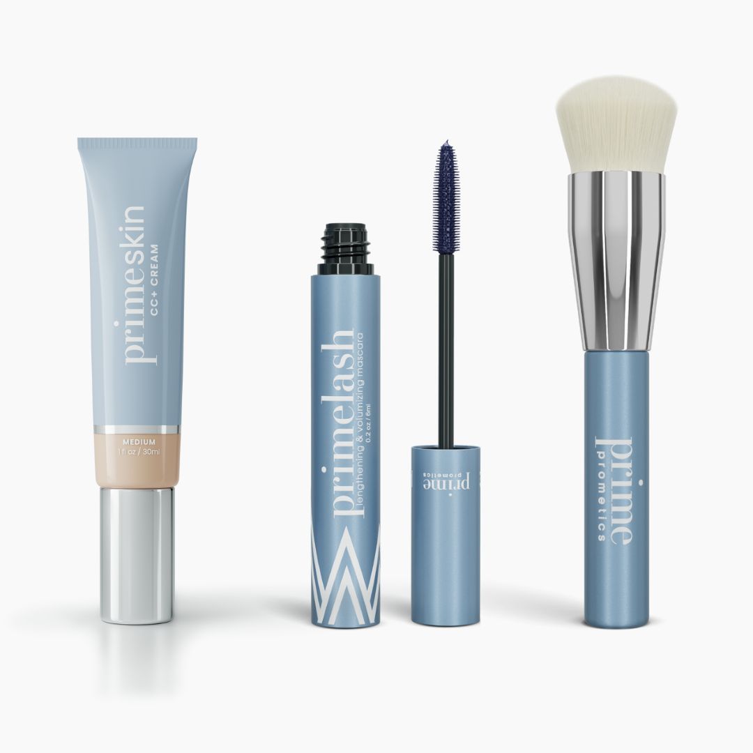 The PrimePrometics™ Effortless Beauty Complete Bundle includes four makeup products with light blue packaging: primeskin CC+ Cream, primelash Mascara with wand open, and a Foundation Brush labeled prime promoteur.