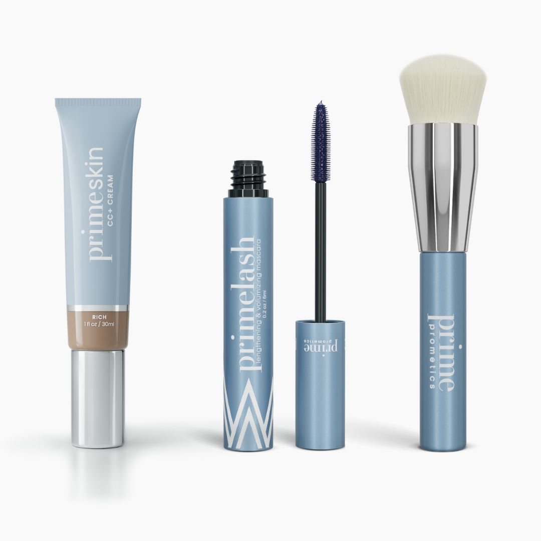 Four PrimePrometics™ Effortless Beauty Complete Bundle products are displayed: a CC+ Cream tube, mascara with wand out, small primer, and a foundation brush with white bristles and a blue handle.