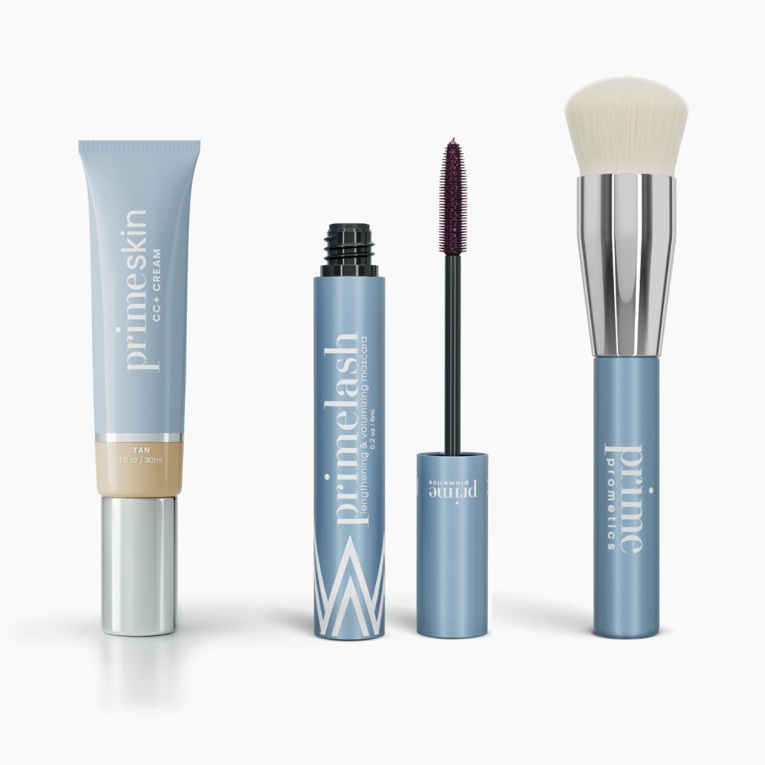 The Effortless Beauty Complete Bundle by PrimePrometics™ features CC+ Cream, Mascara, Lipstick, and a Foundation Brush in sleek blue and silver packaging, all standing upright against a white background.
