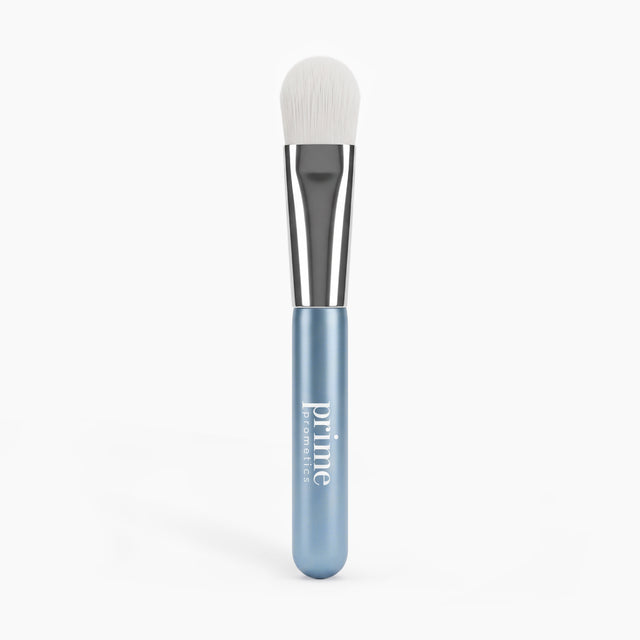 PrimePrometics™ PrimeLift Precision Applicator Brush featuring an ultra-soft white synthetic bristle head, silver ferrule, and metallic blue handle, designed to be gentle on mature skin.