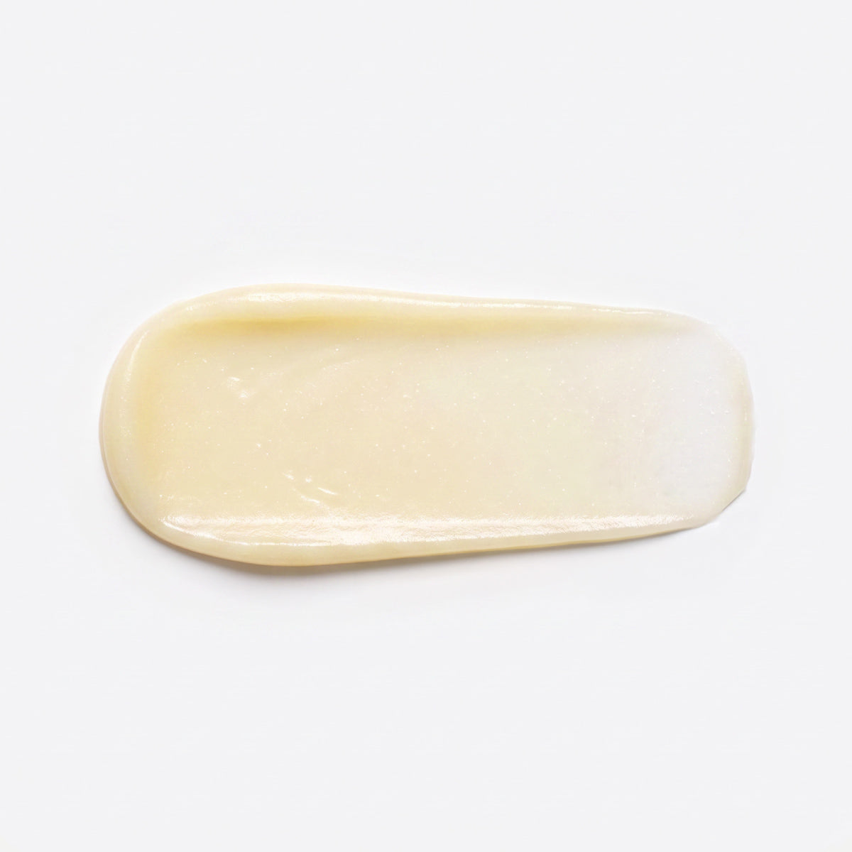Ein Klecks der hellgelben, glänzenden Luxus-Feuchtigkeitscreme „PrimePrometics™ PrimeWand Nourish“ – ideal für reife Haut – ist in ovaler Form auf einem weißen Hintergrund aufgetragen.
