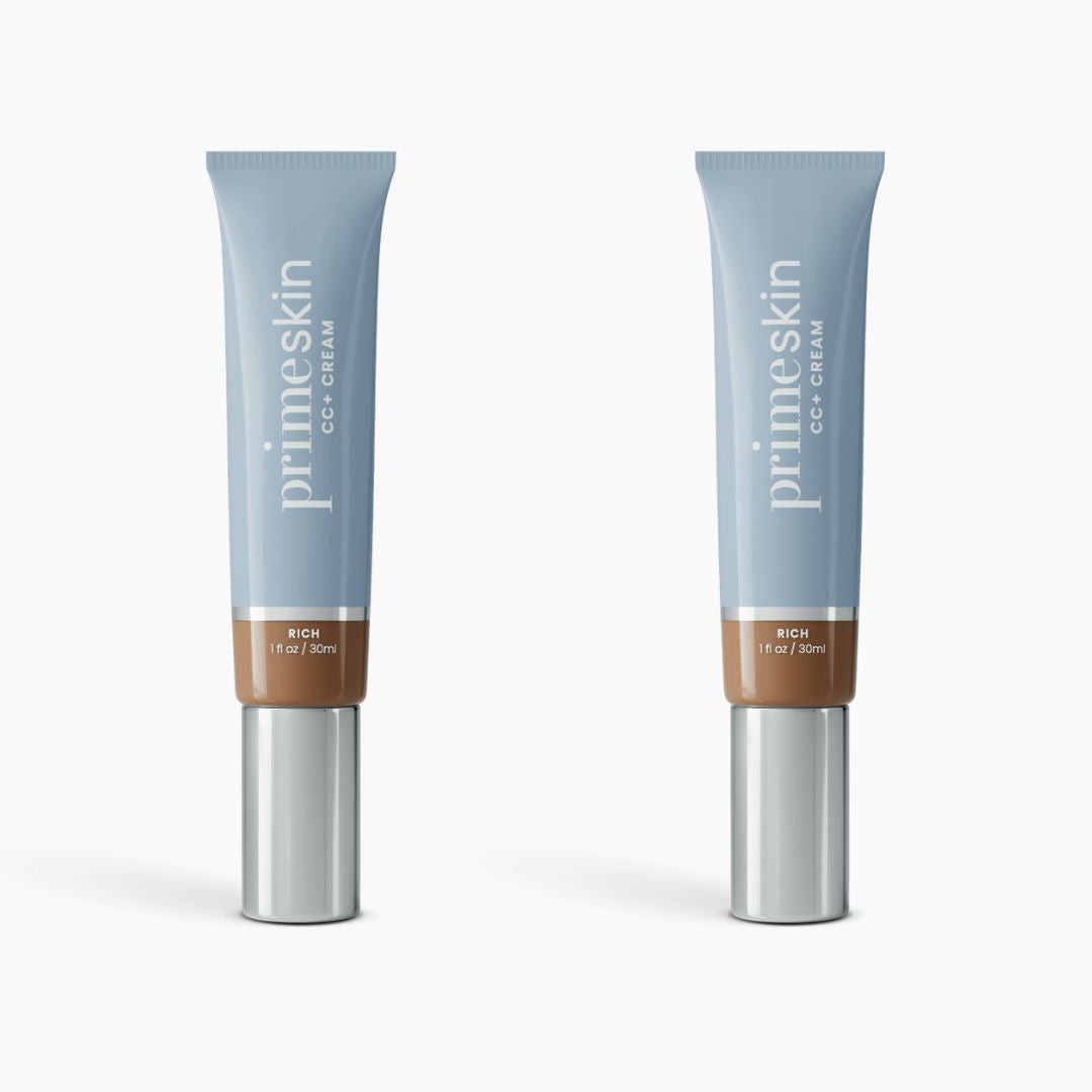 Two identical PrimePrometics™ 2pcs PrimeSkin CC+ Cream tubes, with blue caps, light blue bodies, and silver bottoms, stand upright on white—a lightweight foundation that blurs pores, perfect for women over 50.