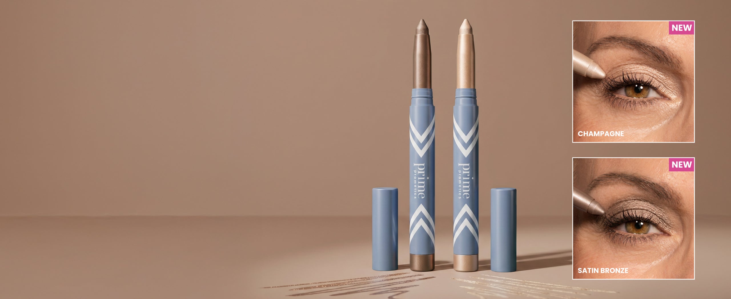 Two metallic eye shadow sticks stand upright on a beige surface, with their caps off. Insets show close-ups of eyes applying the shades Champagne (top) and Satin Bronze (bottom), both labeled “NEW.”.