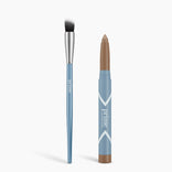 A blue Cream Eyeshadow Brush with a silver ferrule and black-and-white bristles stands next to a blue twist-up stick with a matte brown eyeshadow tip. Both are labeled Seamless Shadow Bundle Matte by PrimePrometics™.