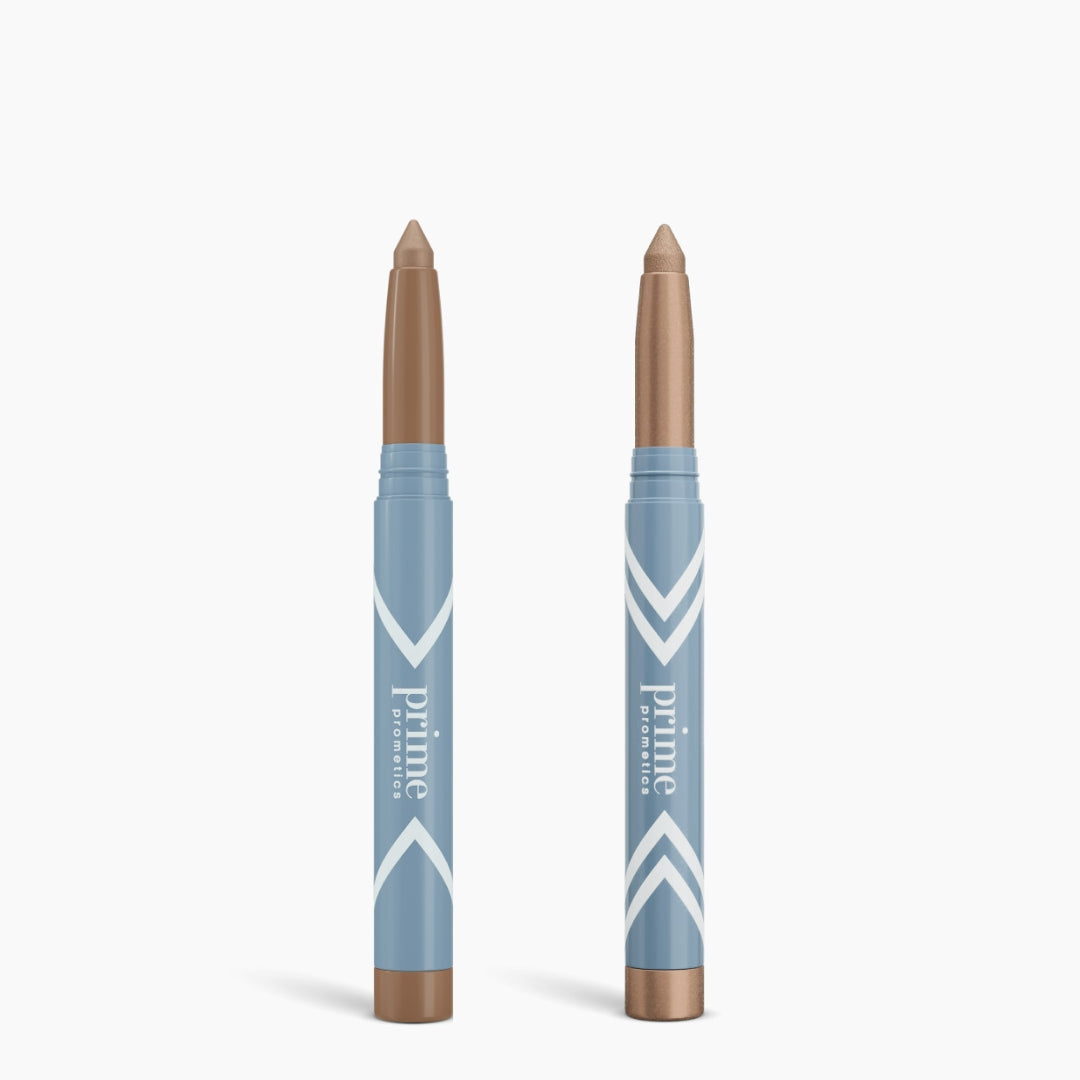 Two blue PrimePrometics™ Complete Eye Sticks Kit stand upright with beige tips and white chevrons, combining Eye Brightener and Matte Eyeshadow to give your eyes a radiant, flawless look against a white background.