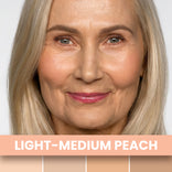A smiling older woman with light blonde hair and peach makeup wears PrimePrometics™ Undereye Brightening Corrector in Light-Medium Peach, shown above four light peach swatches—ideal for disguising dark circles.